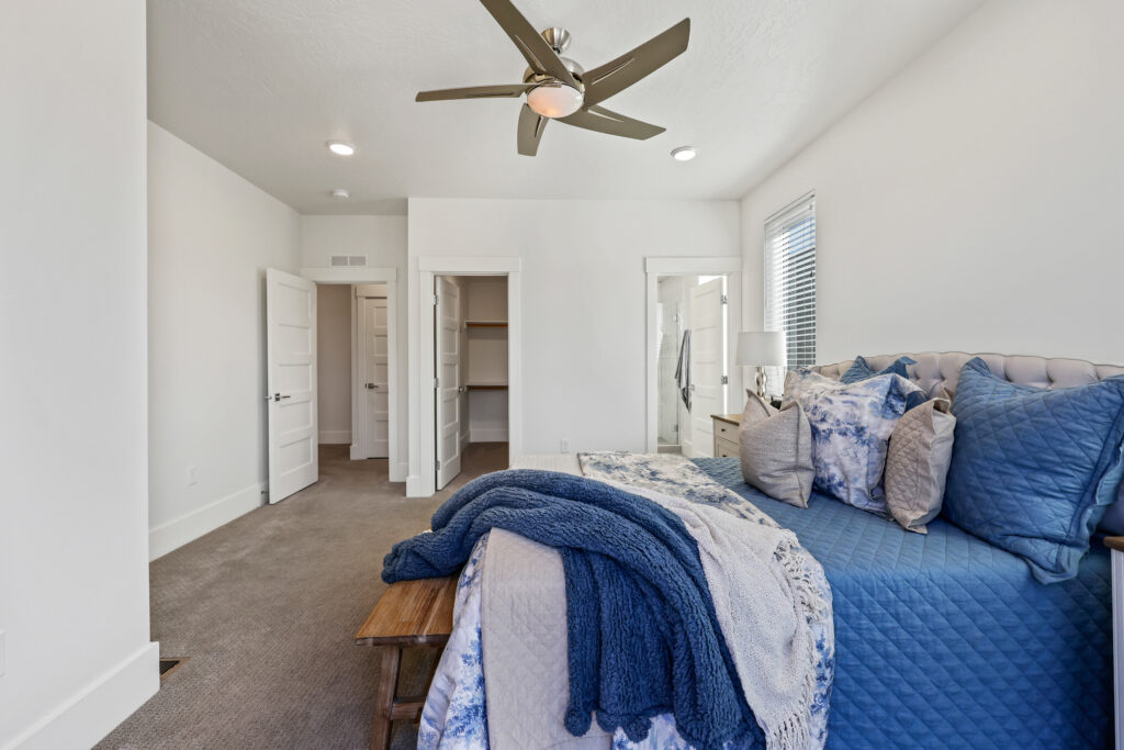 Primary Suite Interior View - Good News Realty Group Bedroom interior with open closet doors, view of hallway and bathroom entry.