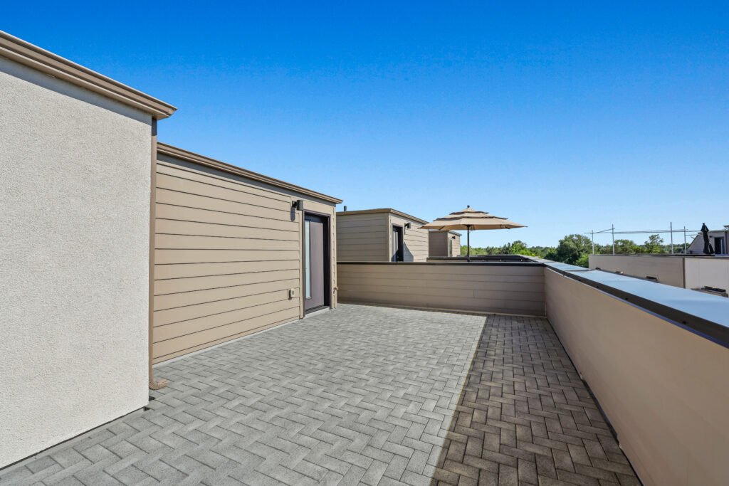 Rooftop Patio View #2 - Good News Realty Group Rooftop deck with umbrella and patio furniture space