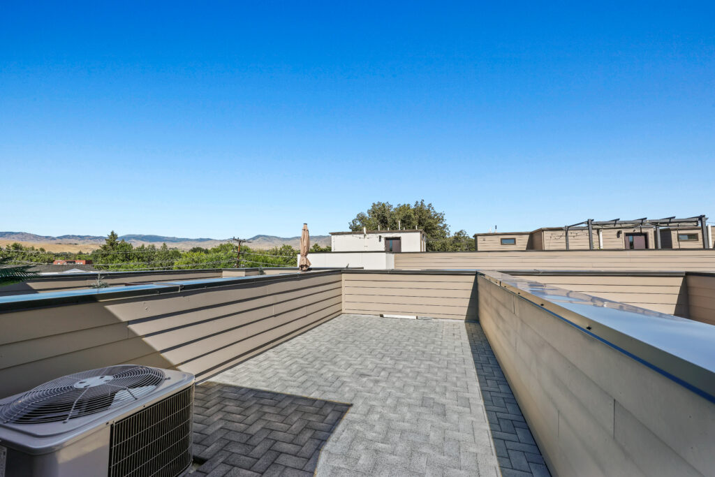 Rooftop View Toward Mountains - Good News Realty Group Rooftop with air conditioning unit and mountain views